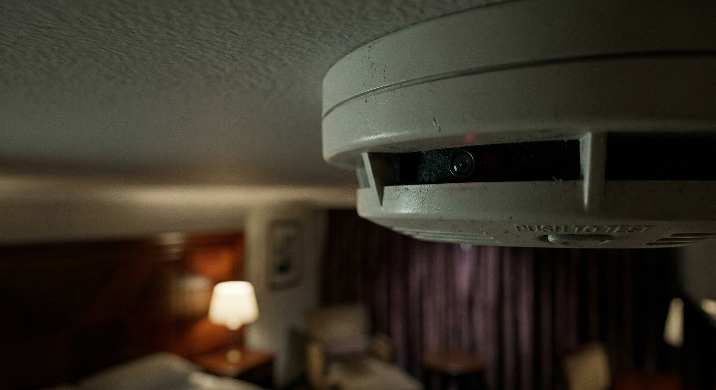 Hidden camera concealed inside a smoke detector in a hotel room